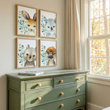 Set of four Australian animal nursery wall art prints featuring a kangaroo koala wombat and platypus with eucalyptus leaves.