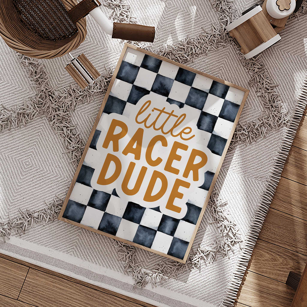 Ochre Little Racer Dude lettering with an off-white outline over softly textured charcoal and off-white checkerboard squares.