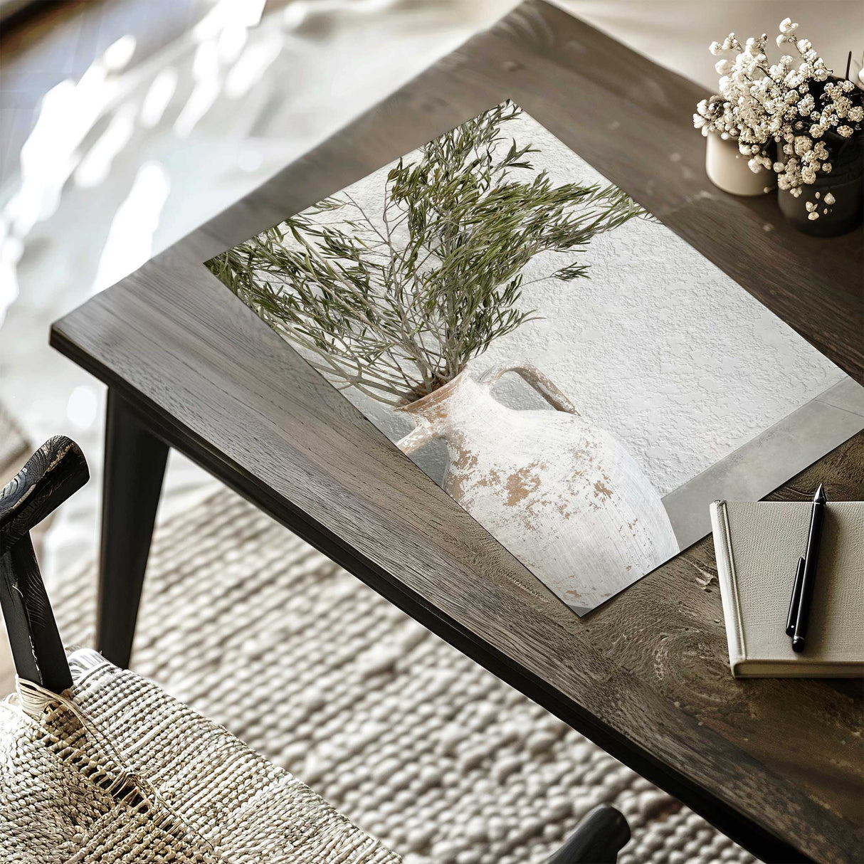 White ceramic vase with olive branches styled in a neutral home decor setting