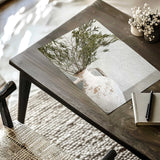 White ceramic vase with olive branches styled in a neutral home decor setting