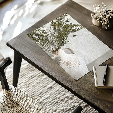 White ceramic vase with olive branches styled in a neutral home decor setting