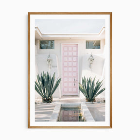 Palm Springs pink door wall art print with white border, mid-century modern home decor photography.