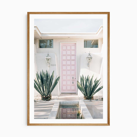 Palm Springs pink door wall art print with white border, mid-century modern home decor photography.