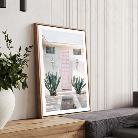 Palm Springs retro home decor wall art print with pink front door and desert plants, white border finish.