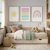 Set of three pastel prints featuring a yellow sun, rainbow and personalised positive affirmations for a girl's room.