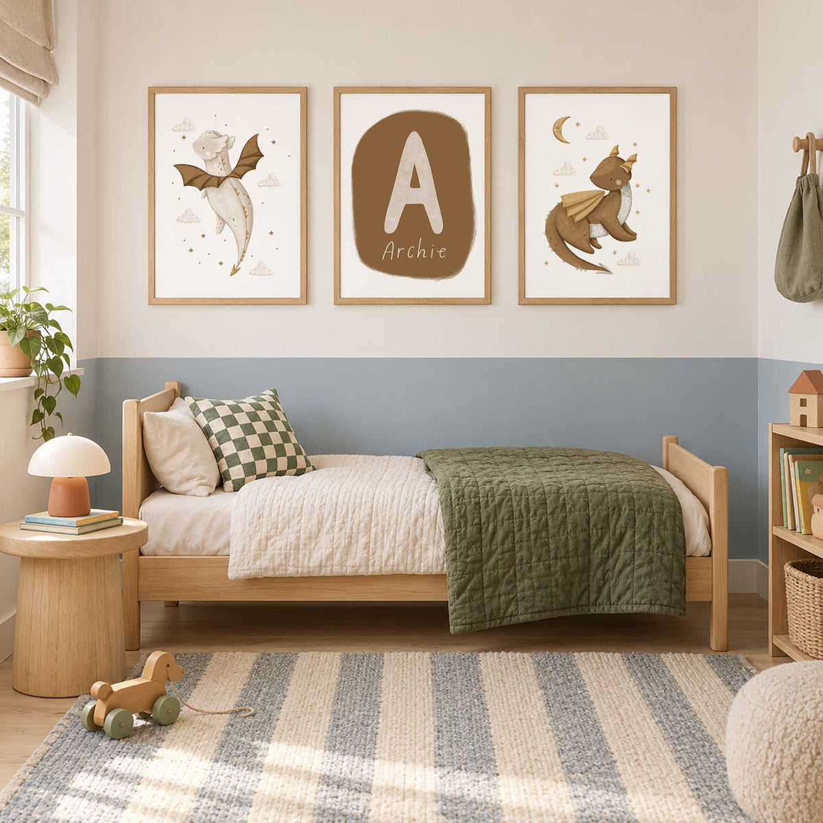 Personalised baby dragon wall art with brown and cream dragons, gold stars, soft clouds and a matching name and initial print.