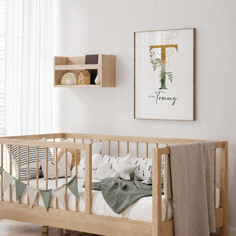 Personalised baby nursery print with large initial, eucalyptus greenery and elegant gold botanical accents.