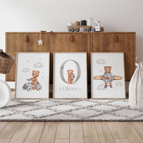 Three personalised bear prints with a ride-on car bear, grey initial and name with balloon bear, and pilot bear.