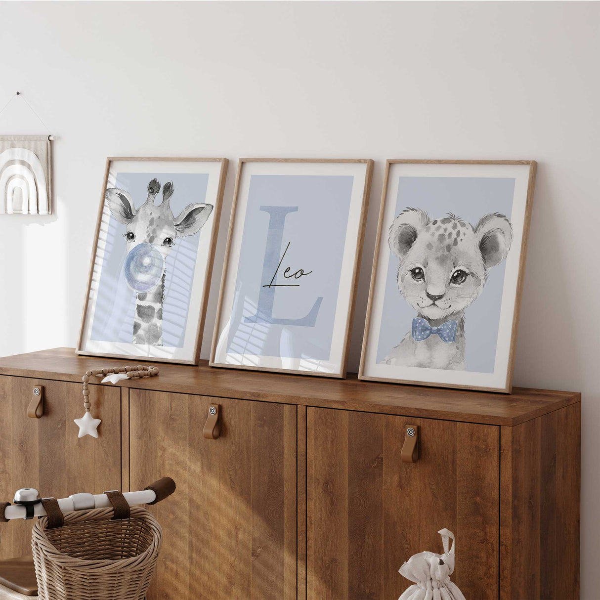 Personalised safari nursery wall art set with giraffe bubble print, custom initial name art and lion cub portrait in soft blue tones