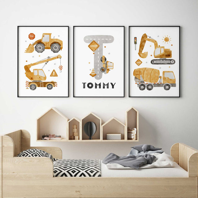 Three yellow construction vehicle prints with a grey road-shaped initial and the Childs name on the personalised centre print.