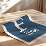 Personalised construction name and initial print with a large white letter and matching name on a coloured background.