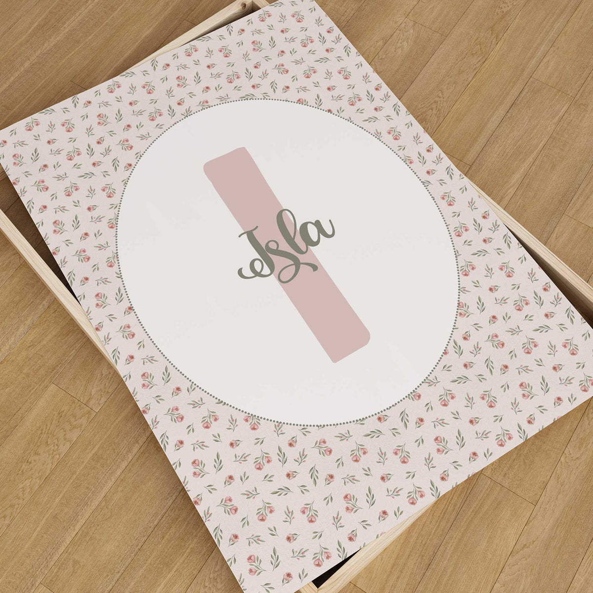Personalised nursery print with a blush pink initial and name in green script, surrounded by pink roses and green leaves.