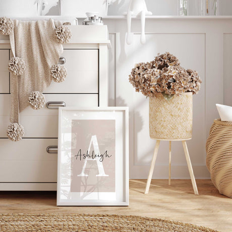 Personalised initial and name wall art with large letter and script name on neutral pink background