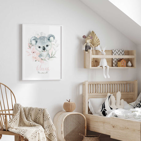 Personalised floral koala print with name in pink script beneath a grey koala, pink flowers and green foliage.