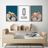 Personalised monster truck set with yellow and red trucks on blue and teal, plus a black initial and name.