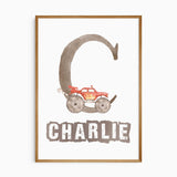 Personalised monster truck name print featuring a large racing-style initial, child’s name and colourful tyre details.