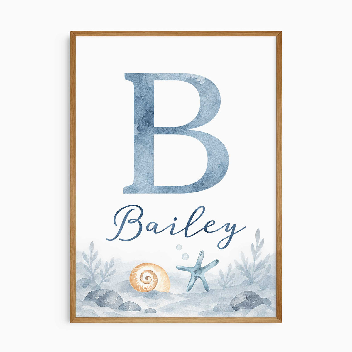 Personalised ocean name print with a blue watercolour initial and name lettering above a shell, starfish and rocky seabed.