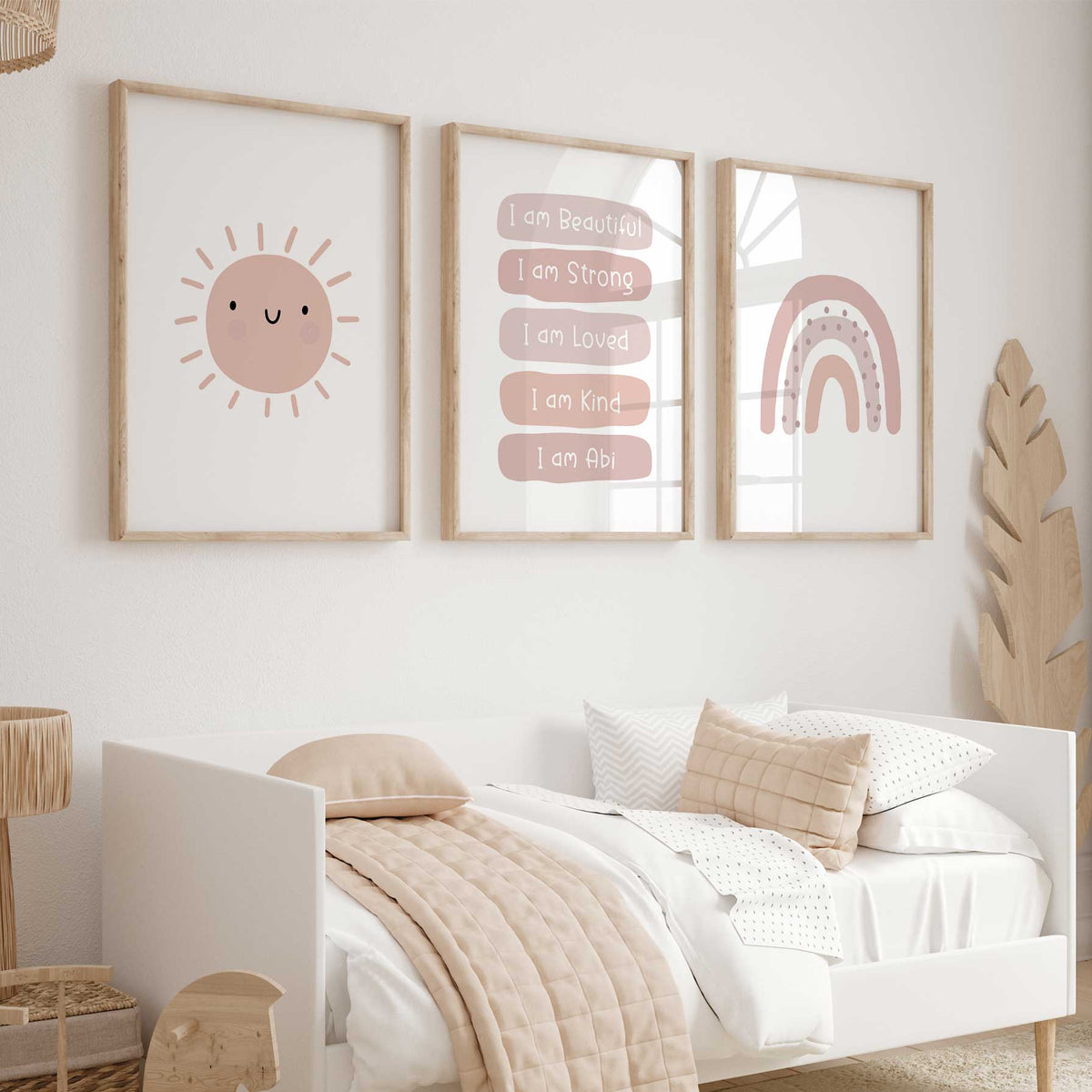 Set of three pink prints showing a smiling sun, personalised affirmations and rainbow