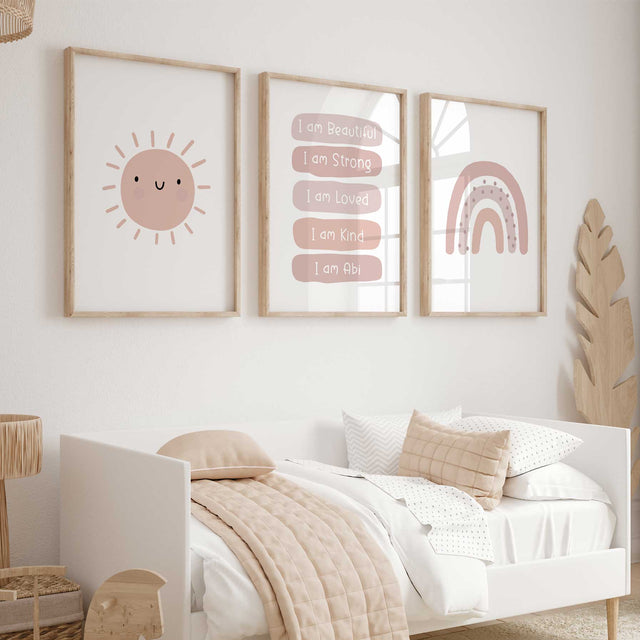 Set of three pink prints showing a smiling sun, personalised affirmations and rainbow