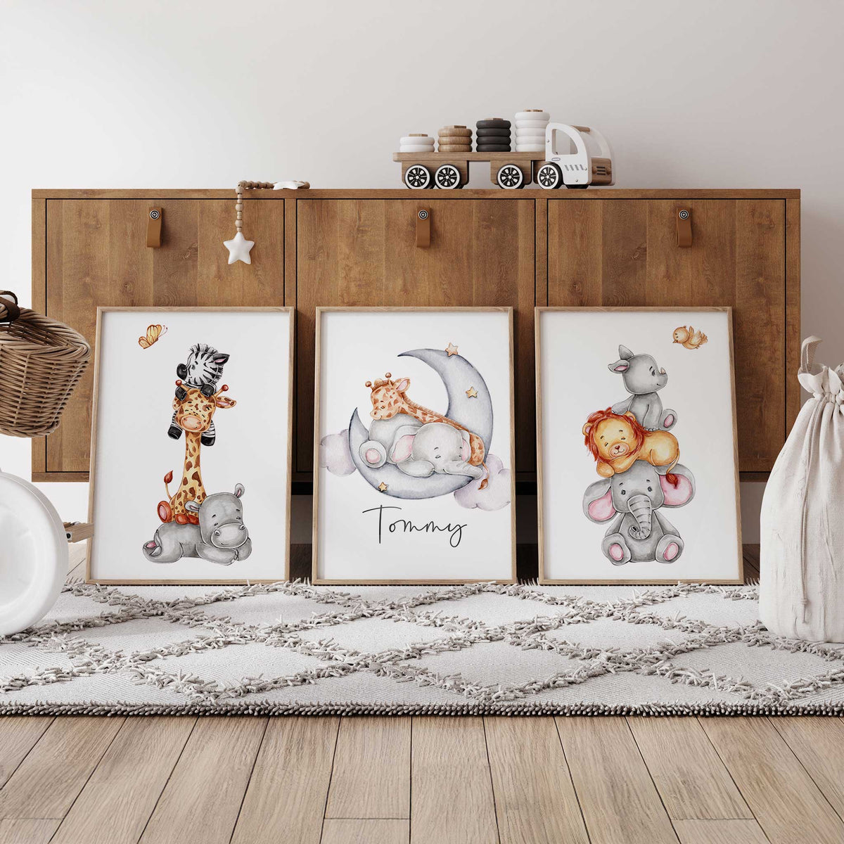 Set of three personalised safari prints with stacked baby animals and an elephant and giraffe on a crescent moon.