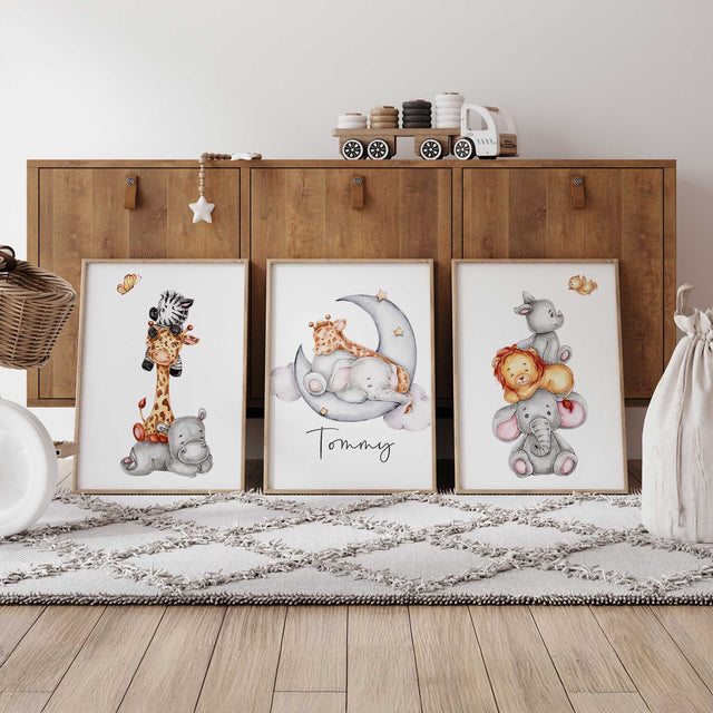 Set of three personalised safari prints with stacked baby animals and an elephant and giraffe on a crescent moon.