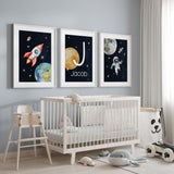 Personalised space nursery wall art set with rocket, astronaut and custom initial name print in deep navy tones for boys bedroom decor