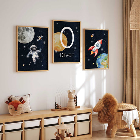 Set of three personalised space prints with an astronaut, rocket and initial name artwork for a child’s bedroom