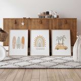Set of three personalised surf prints with pastel surfboards, a rainbow with name underneath and a yellow beach car with palm trees.