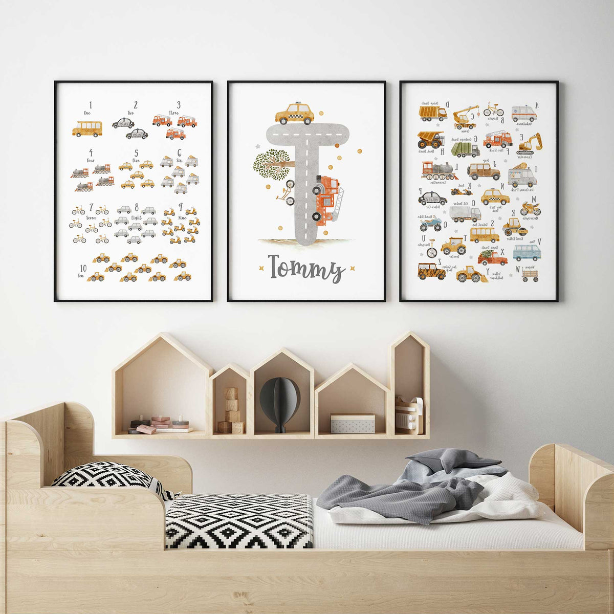 Transport alphabet and counting prints with watercolour vehicles beside a grey road T initial and Tommy name.
