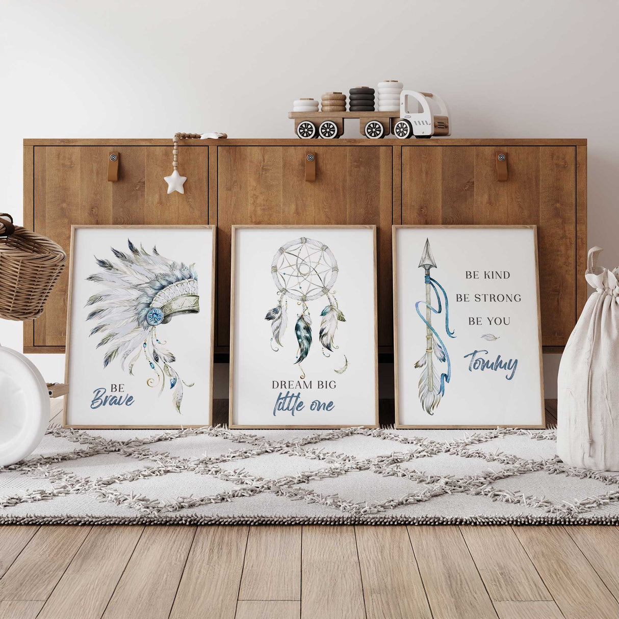 Three framed wall art prints with bohemian-style tribal illustrations and text  The prints feature a feathered headdress, a dreamcatcher, and feathers with motivational phrases like 'BE Brave', 'DREAM BIG little one', and 'BE KIND BE STRONG BE YOU
