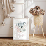 Koala name print featuring name in pink script, with a grey watercolour koala surrounded by flowers and foliage.
