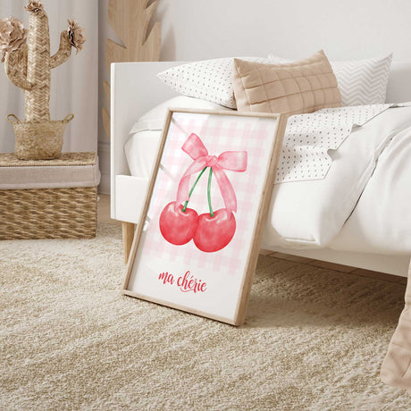 Pink gingham cherry print with two bright red cherries, a pale pink ribbon bow and decorative French lettering.