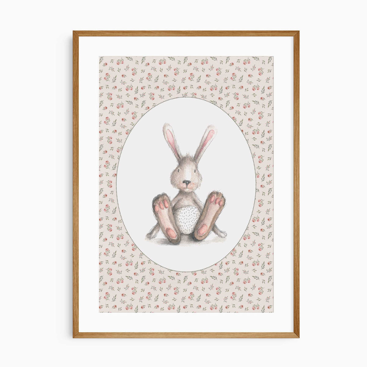 Seated grey-brown bunny with pink ears and paws inside a white oval, surrounded by a pink rose and green leaf pattern.