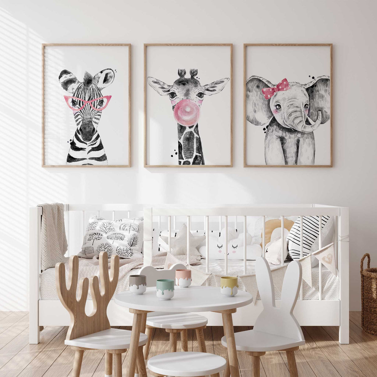 Pink safari animal nursery wall art set featuring zebra with glasses, giraffe blowing bubble gum, and elephant with bow