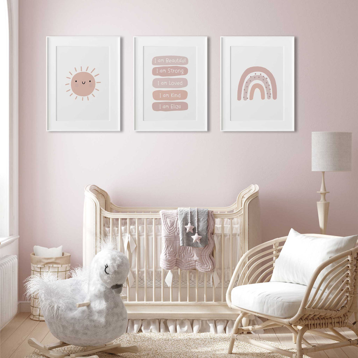 Three pink nursery prints showing a smiling sun, personalised affirmations and rainbow