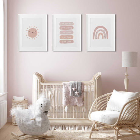 Three pink nursery prints showing a smiling sun, personalised affirmations and rainbow