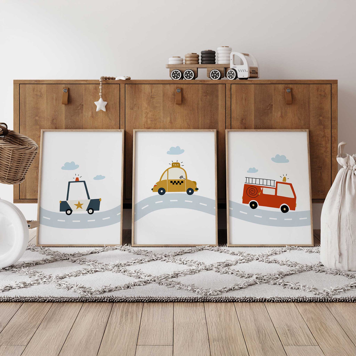 Police car, yellow taxi and red fire engine prints with blue clouds and a winding road across the three designs.