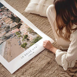Positano photography print showing pastel hillside buildings and a beach, with La Dolce Vita Italia text below.