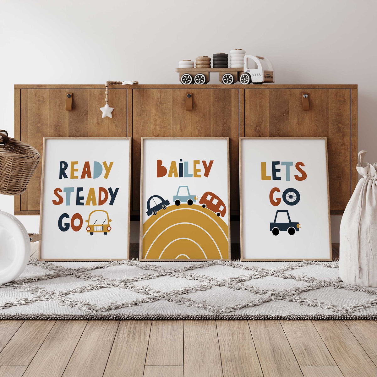 Personalised car prints with Bailey above a mustard curved road, alongside Ready Steady Go and Let's Go car designs.