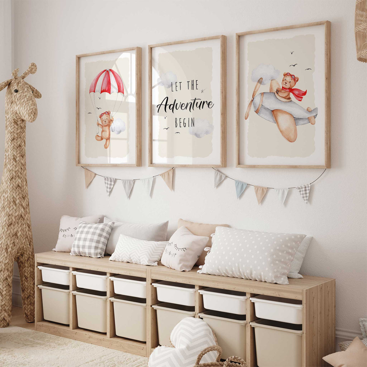 Three nursery prints with a red parachuting teddy bear, a bear flying a plane and matching Let the Adventure Begin wording.