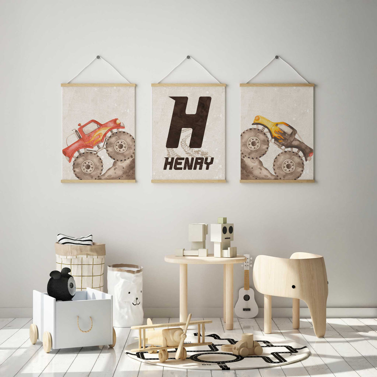 Red and yellow monster truck prints with a personalised Henry initial print, muddy tyres and pale beige backgrounds.