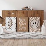 Set of three retro kids wall art prints featuring a smiley face, Good Vibes quote and neutral lightning bolt design