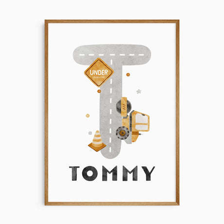 Personalised name print with a grey road-shaped initial, white dashed markings, yellow construction vehicle and traffic cone.