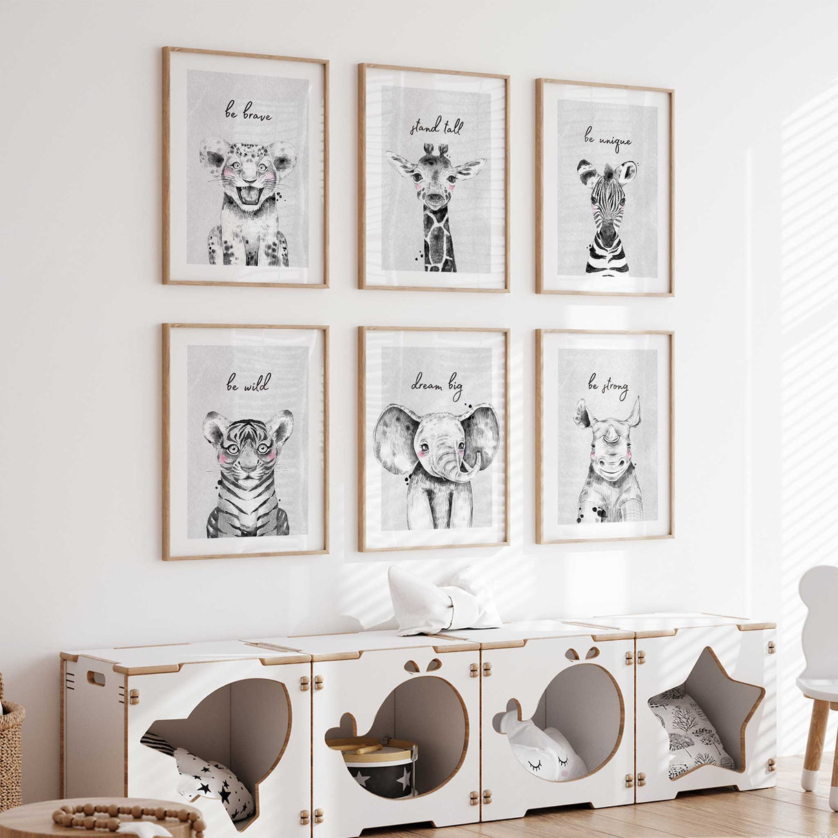 Set of 6 unframed safari animal nursery prints featuring an elephant, zebra, giraffe, rhinoceros, and tiger with inspirational quotes like ‘be brave’ and ‘dream big