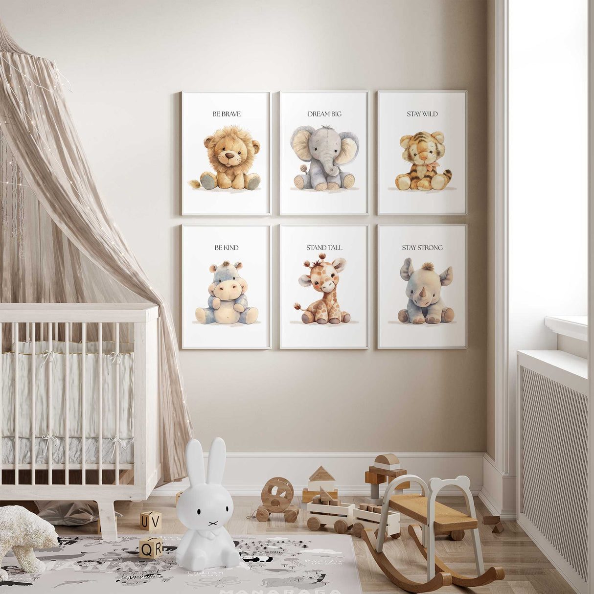 Set of six safari animal nursery wall art prints with positive affirmations including lion, elephant, tiger, hippo, giraffe and rhino displayed in a neutral baby room.