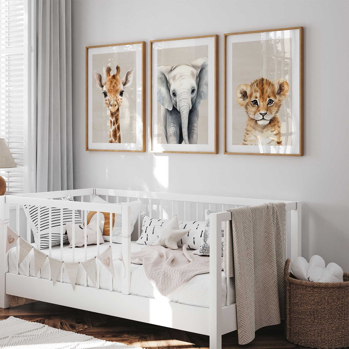 Neutral safari animal nursery wall art set featuring giraffe, elephant and lion prints for a modern Scandinavian kids room.