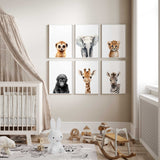 Set of six neutral safari animal nursery wall art prints featuring baby elephant, giraffe, zebra, cheetah, gorilla and meerkat displayed as a gallery wall in a modern baby nursery with cot and wooden toys, designed for gender neutral baby room decor