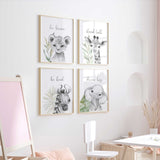 A set of four black and white safari-themed wall art prints featuring illustrations of a lion, elephant, giraffe, and zebra. For kids nursery or bedroom
