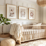 Neutral safari animal wall art set of three featuring a lion, zebra and elephant in soft beige and brown tones.
