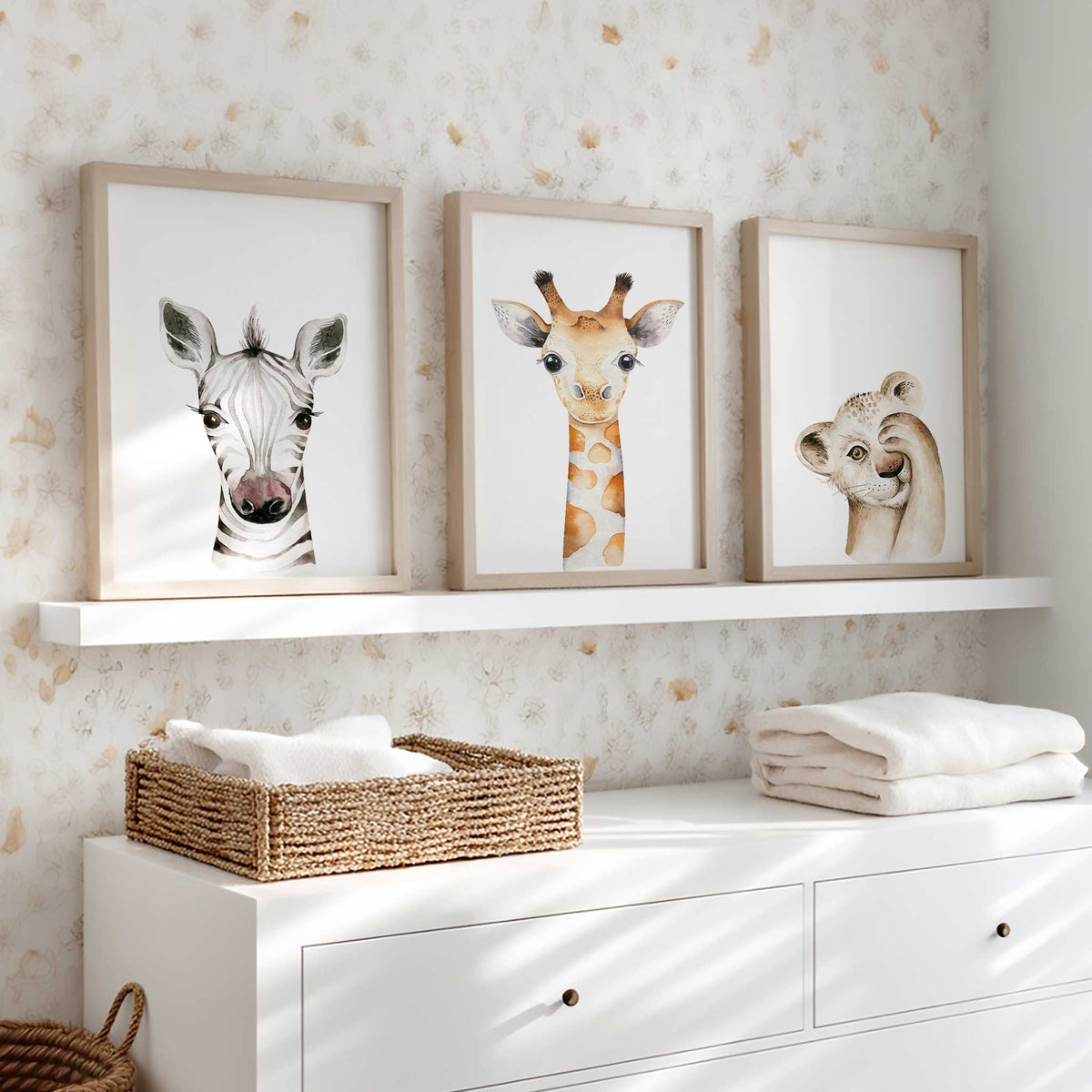 Coordinated lion cub, giraffe and zebra watercolour prints for a toddler bedroom, with animal portraits on white backgrounds.